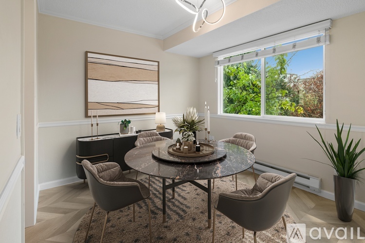 A modern dining room with a glass table and chairs.