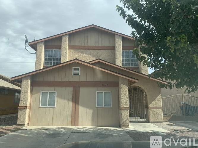 A house with a garage door and a driveway in front.