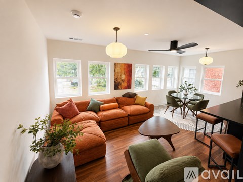 A living room with a brown sofa and a wooden coffee table.