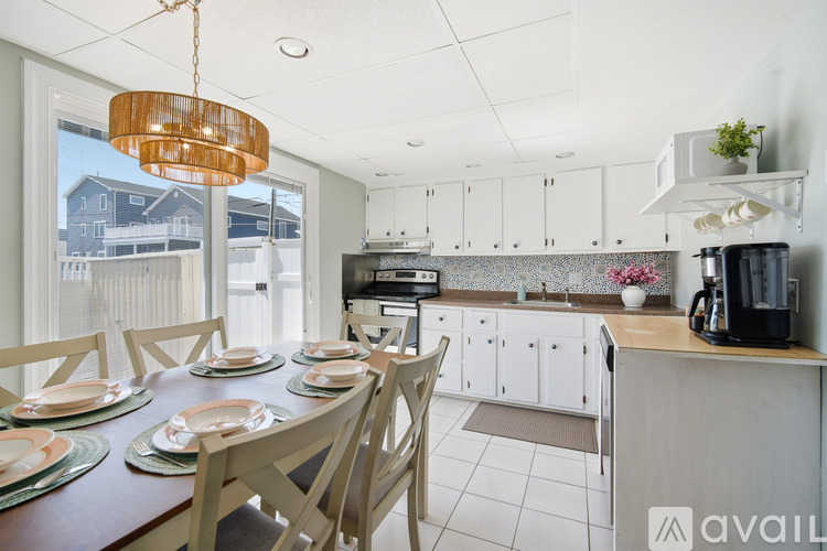 A kitchen with a dining table set for six.