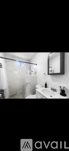A bathroom with a white sink and a mirror above it.