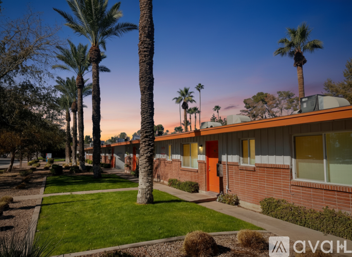 A row of palm trees in front of a building with orange doors.