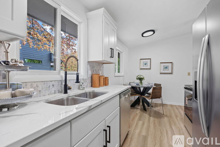 A kitchen with a table set for two and a fridge on the right.