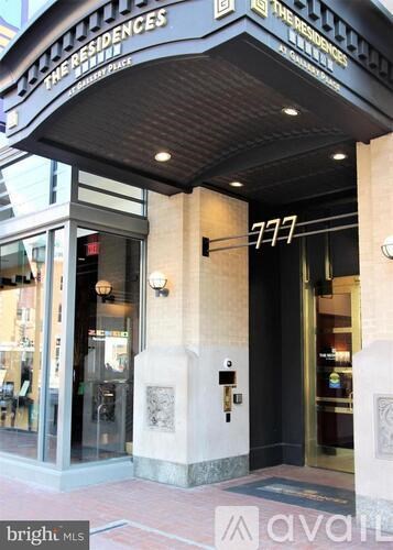 The front of a building with a black awning and a sign that says "The Residences".