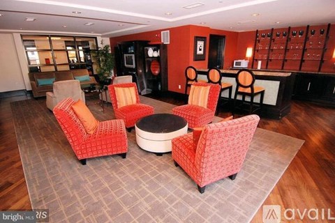 A living room with a red couch and a round table.