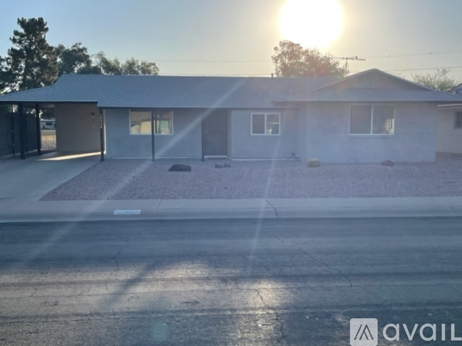 A house with a sunset in the background.
