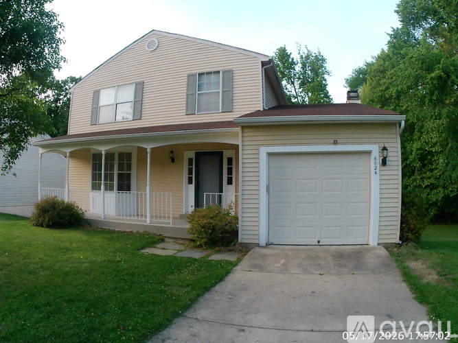 A two-story house with a garage on the right side.
