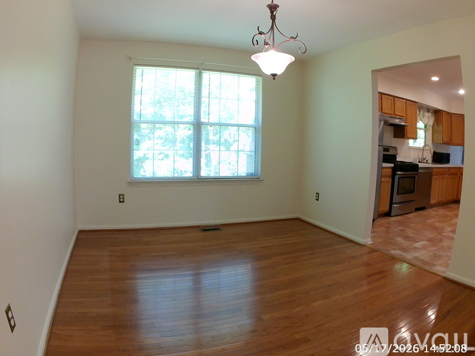 A room with a wooden floor and a window.
