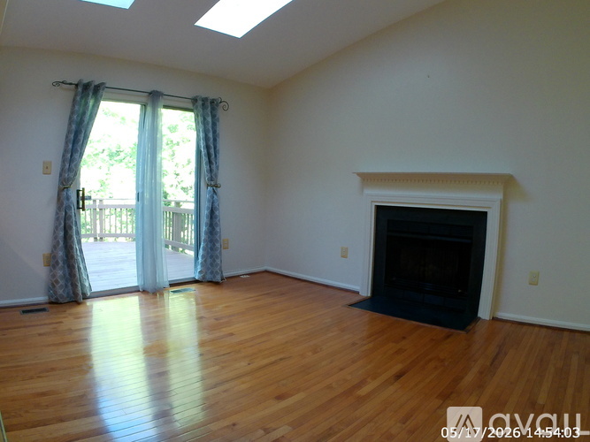 A living room with a fireplace and sliding glass doors.