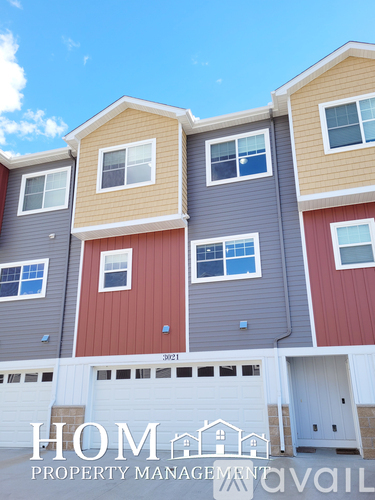 A multi-story building with a sign that says "HOME PROPERTY MANAGEMENT" in front of it.