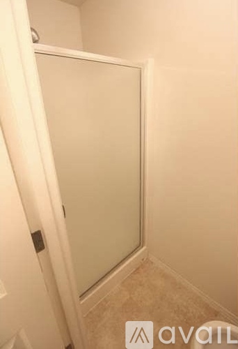 A white door with a glass panel is closed.