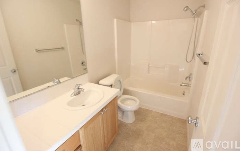 A bathroom with a sink, toilet, and bathtub.