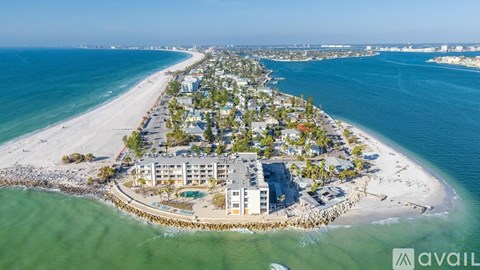 A beachfront property with a large building and a swimming pool is available for sale.