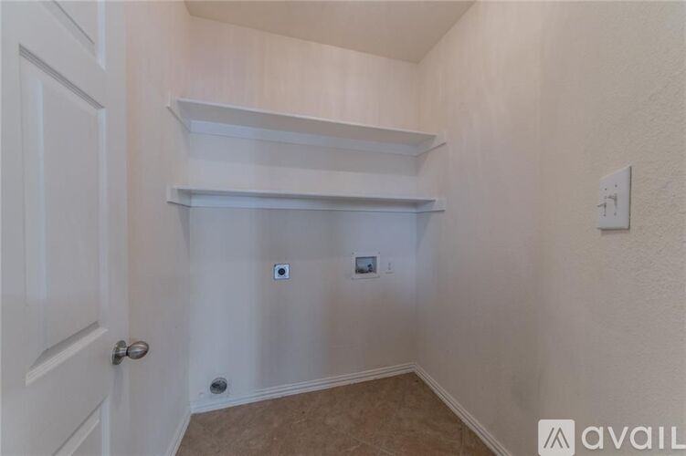 A white door is on the left and a white light switch is on the wall.