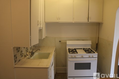 A kitchen with a stove and sink.