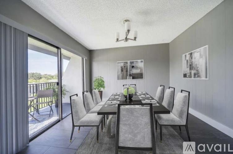 A dining room with a long table and chairs.