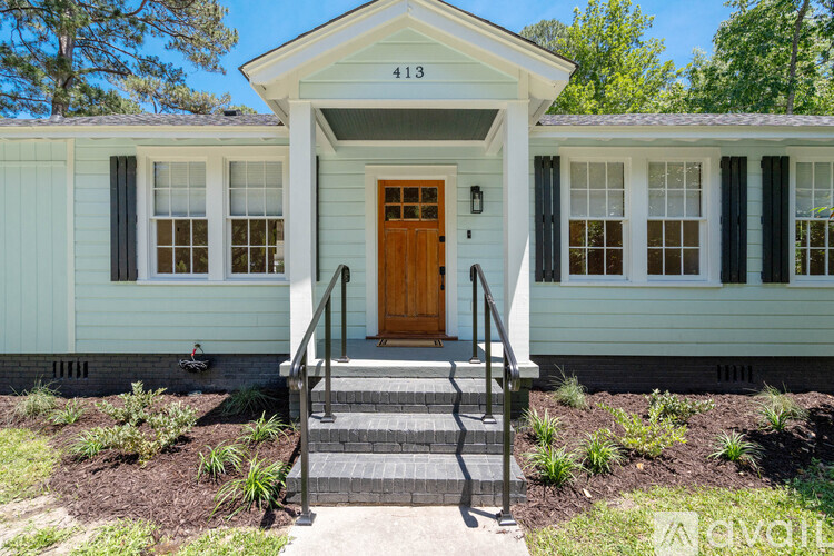 A small house with a brown door and a porch.