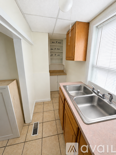 A kitchen with a sink and a cabinet.
