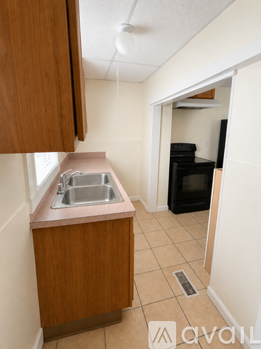 A kitchen with a sink and a microwave.