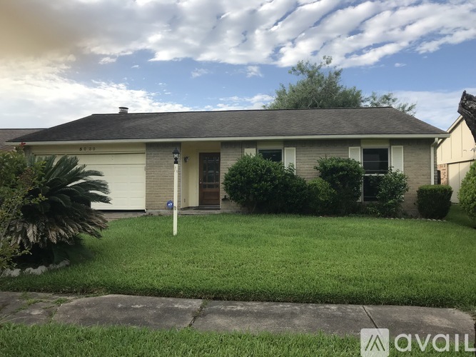 A house with a lawn and a sign that says "AVAIL" in the front yard.