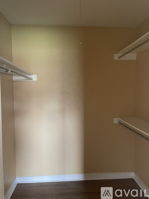 A room with a white ceiling and a white shelf on the wall.