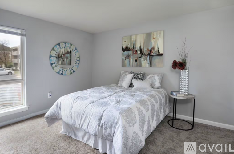 A bedroom with a large bed and a clock on the wall.