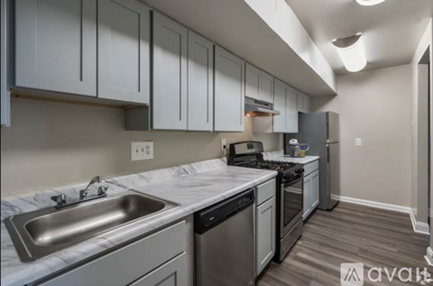 A kitchen with a stainless steel sink and dishwasher.