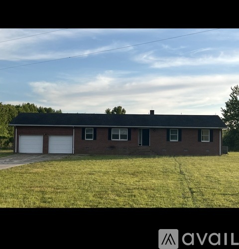A house with a black roof and a chimney is available for sale.