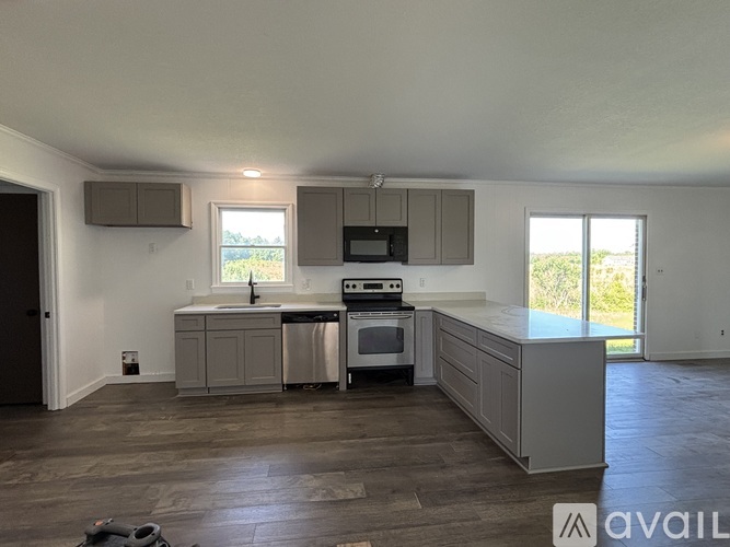 A kitchen with a stove top oven and a dishwasher.