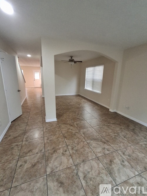 A room with tiled flooring and a ceiling fan.