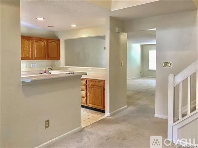 A kitchen with wooden cabinets and a countertop is visible.