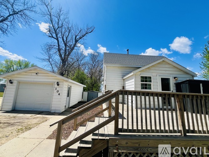 A house with a garage and a deck is for sale.