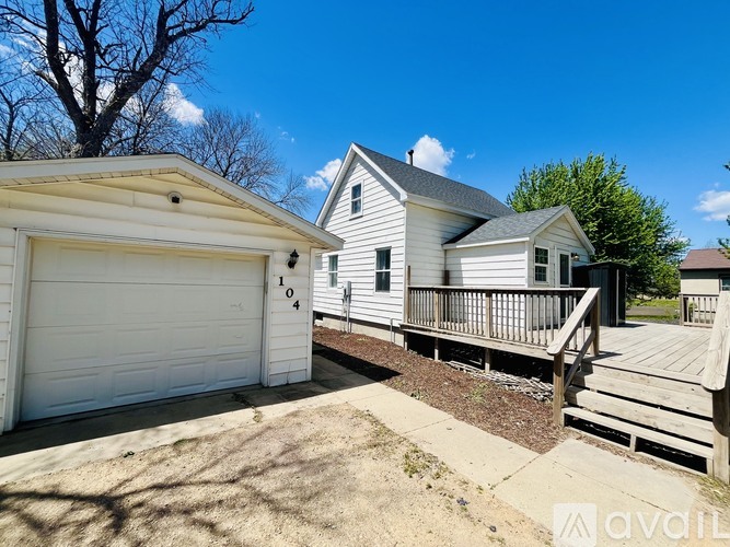 A house with a white garage door is for sale.