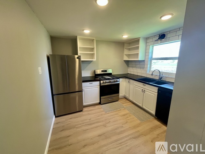 A kitchen with a refrigerator, stove, and oven.