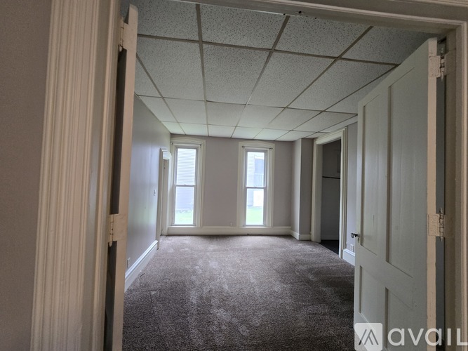 A room with carpeted floor and white walls.