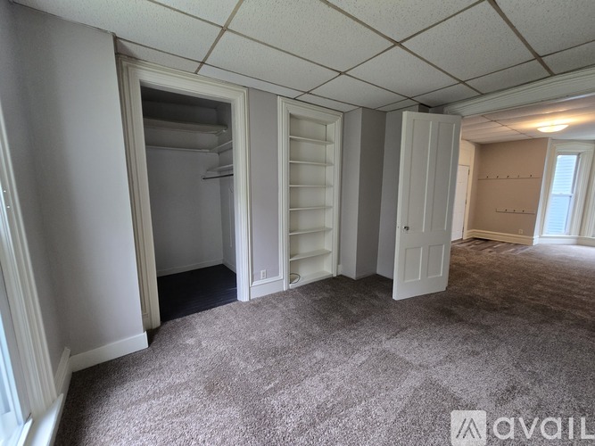 A room with a carpeted floor and a white ceiling.