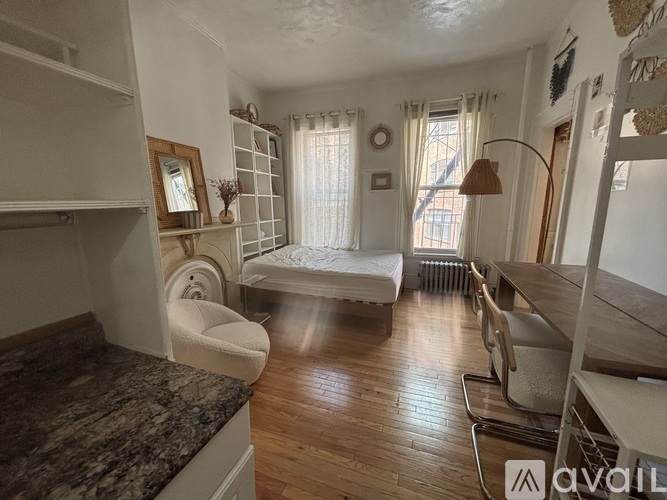 A room with a desk and chair in it.