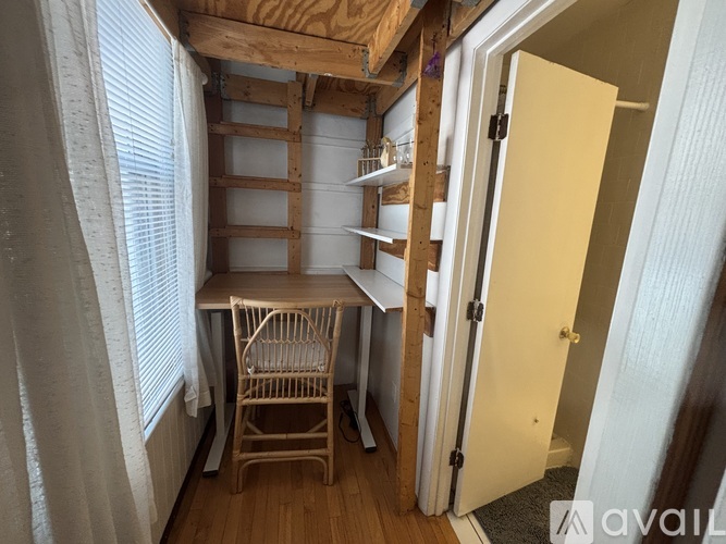A white bathroom with a toilet, sink, and mirror.