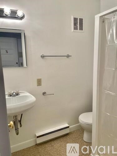 A bathroom with a sink, toilet, and shower.