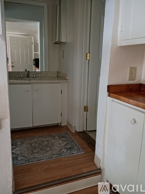 A bathroom with a sink and a mirror.