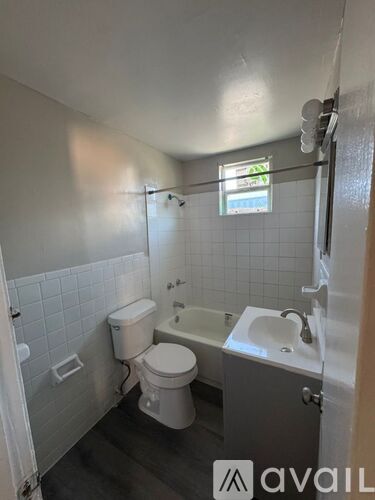 A bathroom with a toilet, sink, and bathtub.