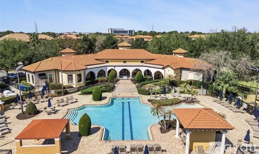 A large building with a pool in front of it.