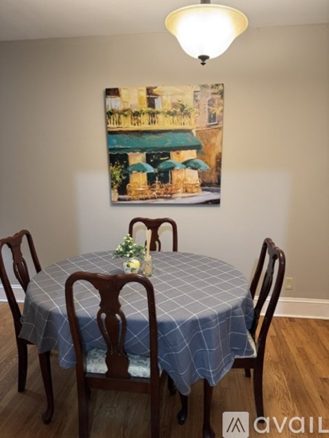 A dining room with a table set for four.