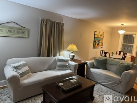 A living room with a white couch and a coffee table.