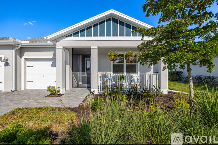 A modern house with a white exterior and a large front yard.