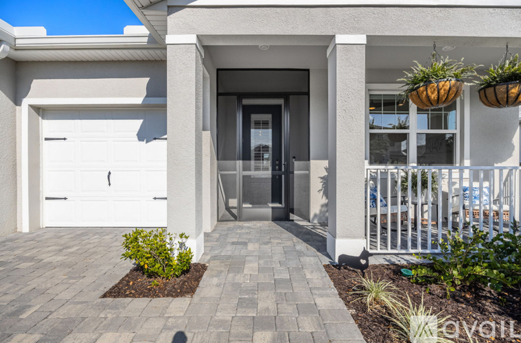 A modern house entrance with a white garage door and a glass door.