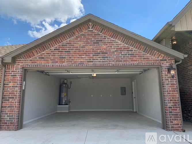A brick building with a garage door open.