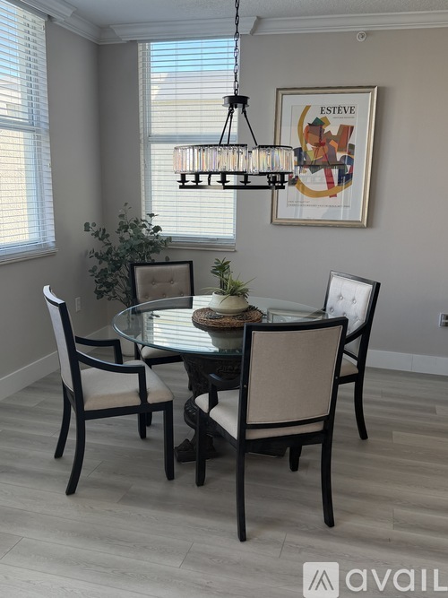A dining room with a glass table and chairs.