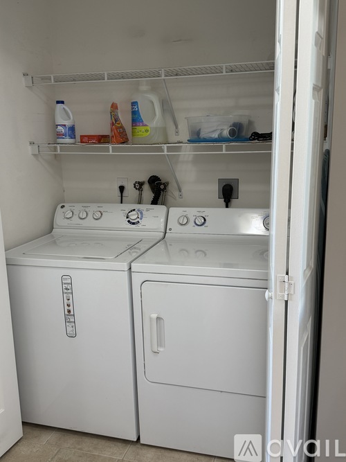 A white dishwasher and oven in a kitchen.