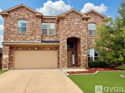 A brick house with a garage door and a driveway.